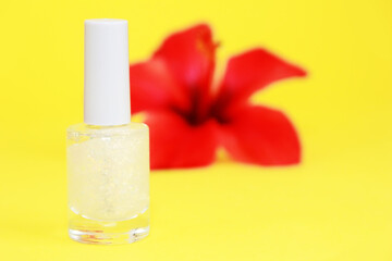 nail polish in a glass bottle on a yellow background