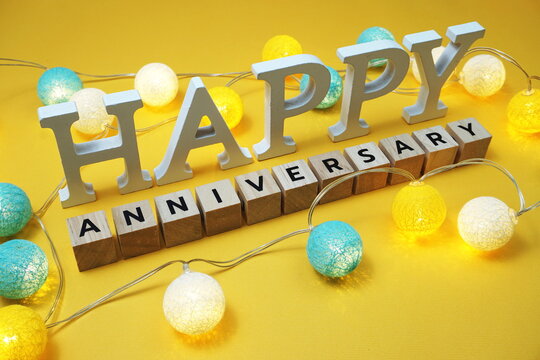 Happy Anniversary alphabet letter with LED cotton balls on yellow background
