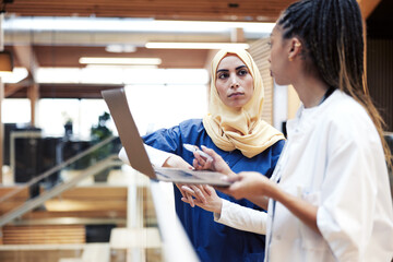 Two female doctors working on a laptop