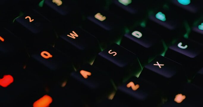 Closeup of illuminated mechanical keyboard keys in motion