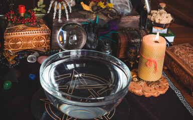 Candle magic at home, Pagan and occultism concept.   Candle on a table, magical stuff, spells and...