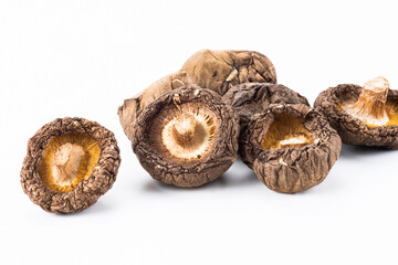 Close-up of dried shiitake mushrooms isolated on white background.