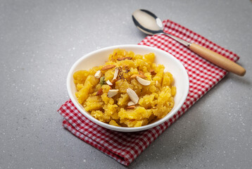 Moong Dal Halwa or Mung Daal Halva is an Indian dessert recipe, made with mung lentil, clarified butter and sugar, garnished with dry fruits