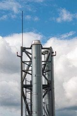 high metal pipe against cloudy sky