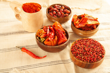 Red colored food. Dried healthy food spices. Dried tomatoes, dried peppers, rosehips, red pepper seeds, red pepper.