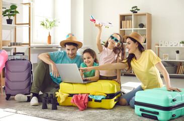 Happy excited family and daughter children buying payment for flight ticket booking hotel online...