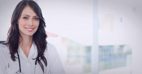 Portrait of caucasian female doctor wearing lab coat smiling at hospital