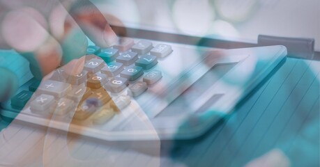 Digital composite image of person using calculator against face mask on white surface