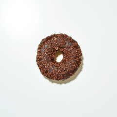 Delicious chocolate donut with sprinkles on white background, top view