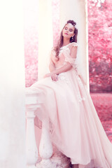 Obraz na płótnie Canvas Romantic Bride Outdoor. Woman in pink Wedding Dress Outside. Fashion Bridal Gown. Fantasy Pink Garden Park Background