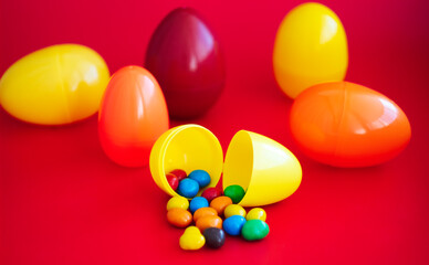 colorful candy spills out of plastic Easter eggs.