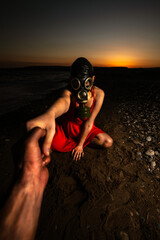 Girl in Red Dress with Gas Mask Holding Hand