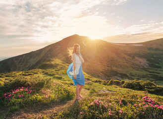 Naklejka na ściany i meble Woman feel freedom and enjoying the mountaine nature at sunset