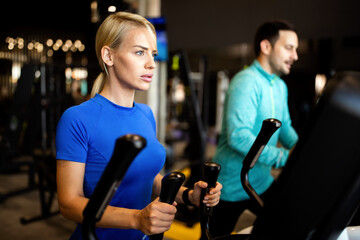 Happy people working out on treadmills in the gym