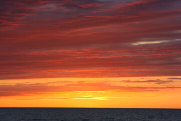 Naklejka na ściany i meble red sunset over the sea