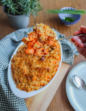 Pasta Bake. Red Pasta With Breadcrumbs In The Oven. Oven-baked Macaroni With Red Sauce Cheese And Breadcrumbs On A White Bake Dish.