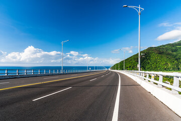 Fototapeta premium Asphalt road with blue sky in the countryside of Taitung, Taiwan.