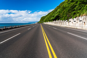 Asphalt road with blue sky in the countryside of Taitung, Taiwan.