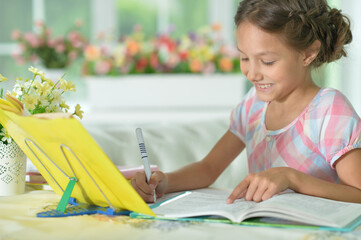 little cute girl doing homework  at home