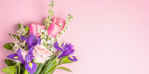 A beautiful bouquet of fresh flowers on a pink pastel background
