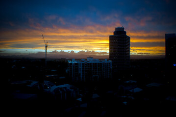 bright sunset on the Gold Coast, Queensland with a silhouette of a crane and a hotel