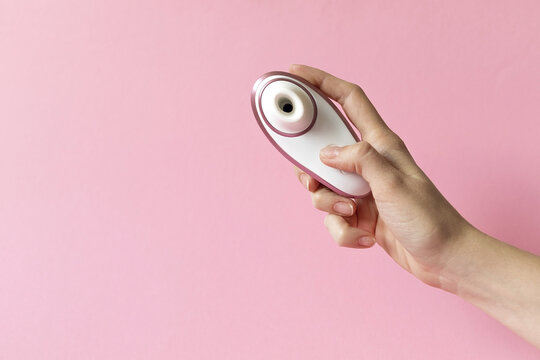 Sex toy for women, female hands holding a masturbator