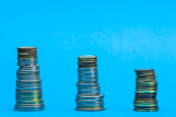Money stacks. Coins descending in columns. Concept of recession and financial crisis. Coronavirus...