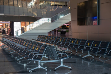 Several rows of seats in the airport's international terminal are completely empty. There are no passengers at the airport . No people at the airport during the covid 19 coronavirus pandemic.