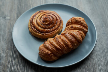 puff pastry. two buns of different shapes on a plate. one round the other elongated