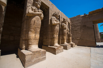ancient statues in old temple in Luxor with clear blue sky 