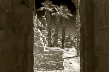 black and white view of ancient ruins from shadowed entrance hall 
