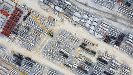 Aerial view of Heavy equipment parts in construction New industrial factory. Raw industrial material in cargo port at industrial estate for import export around in the world