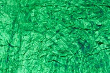 A Close up picture of an Handmade Paper painted in Vibrant green color makes for a brilliant background for Web designing in Still and video editing.
