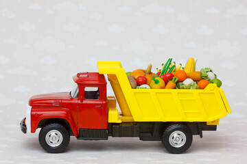 peasant farm vegetables shipping. A  toy lorry delivering fresh fruits and vegetables 