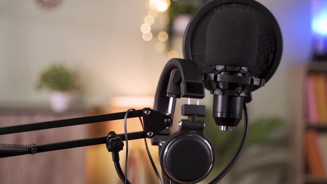 Pan shot of boom arm with microphone and headphones