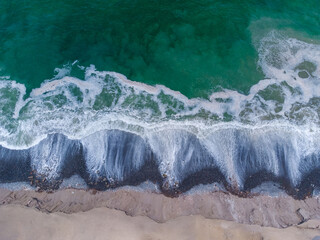 Aerial view of the waves when reaching the shore
