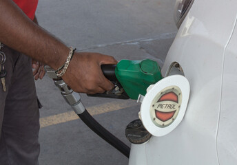 A Close up view of a Petrol filling into a Car fuel tank scene at a Gasoline pump near Mysuru...