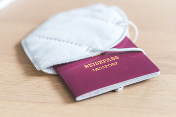 Passport pandemic vacation concept: Close up of passport, ffp2 protection mask, &ldquo;Reisepass Passport&rdquo;