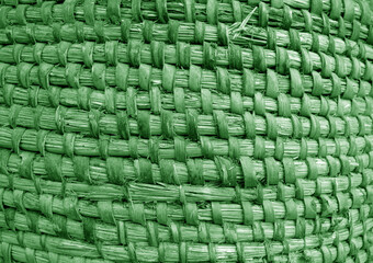 Old hand crafted basket made from dry grass in green tone.