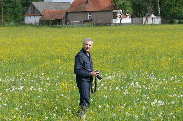 man photographing flowers