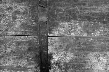 Old rusted and stained floor pattern in black and white.