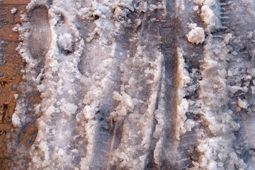 Melted snow and snow slurry on the sidewalk