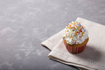 Tasty party cupcakes on the table. Cupcakes with whipped cream.