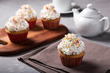Tasty party cupcakes on the table. Cupcakes with whipped cream.