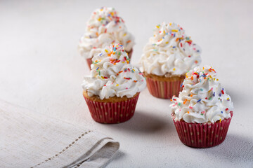 Tasty party cupcakes on the table. Cupcakes with whipped cream.
