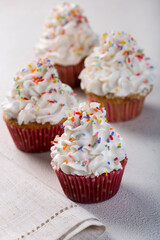 Tasty party cupcakes on the table. Cupcakes with whipped cream.