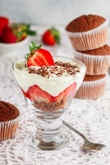 Trifle. Layered Dessert of chocolate sponge cake, whipped cream or ricotta and fresh strawberries in a glass bowl. Delicious gourmet breakfast. Selective Focus