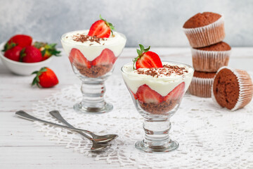 Trifle. Layered Dessert of chocolate sponge cake, whipped cream or ricotta and fresh strawberries in a glass bowl. Delicious gourmet breakfast. Selective Focus