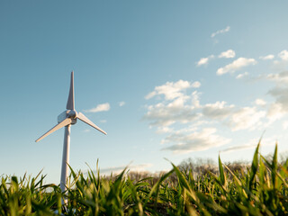 toy wind turbine on a green wheat field