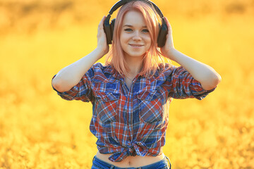 audio headphones summertime girl music in a field of flowers, young female spring